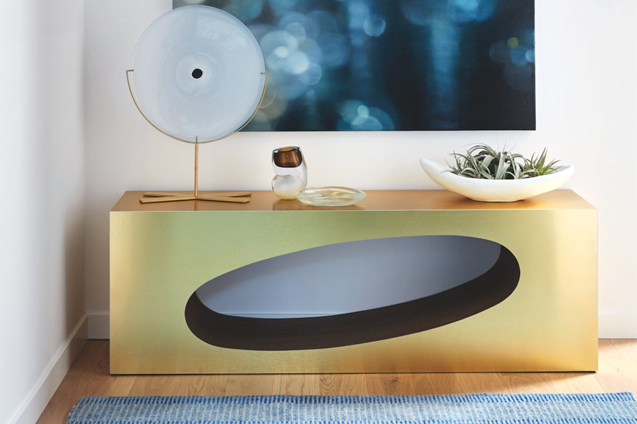 Custom furniture design - brass SENTIENT contemporary designed Orbit coffee table with oval cutout in luxury walnut with sculpture on top