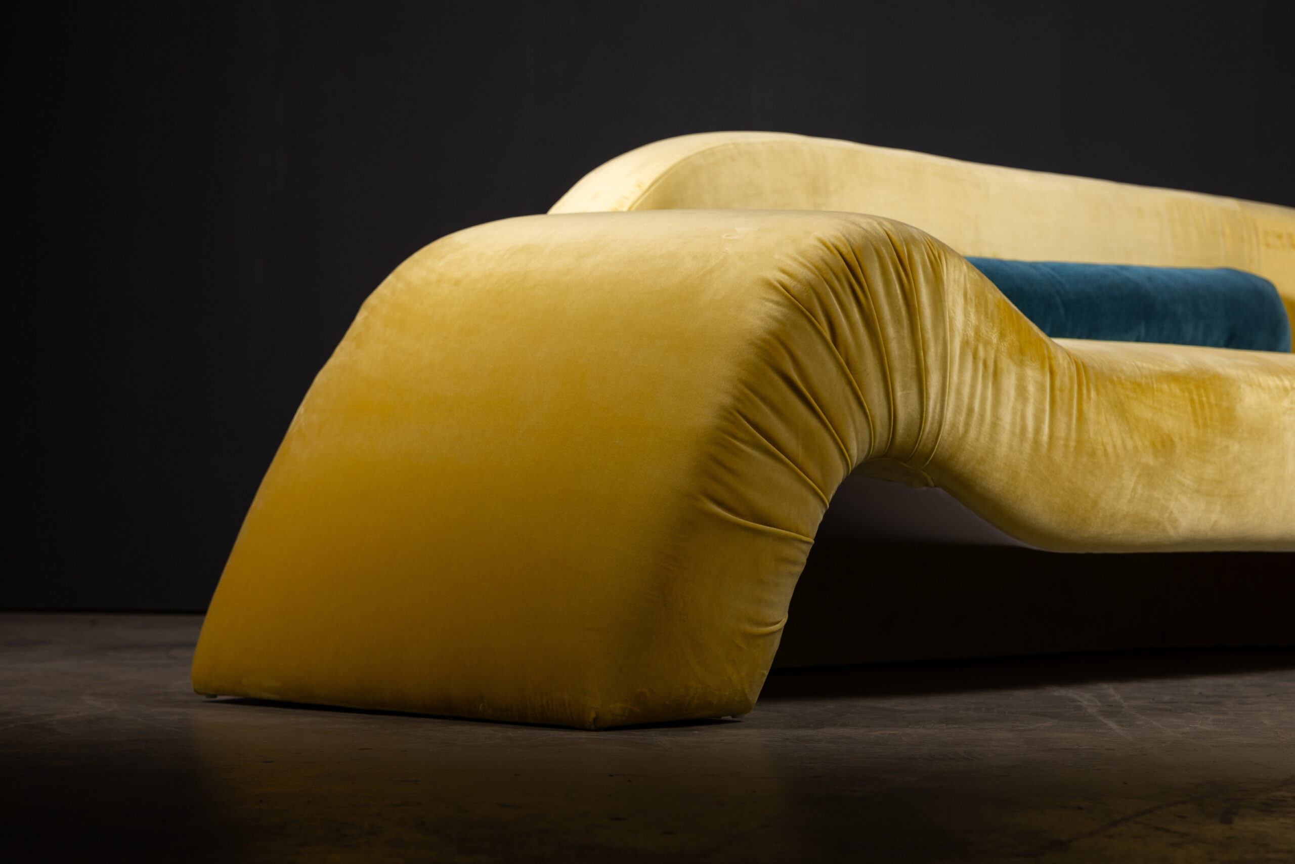 Sentient Aeon Sofa in Yellow Velvet (Side Angle View) A side-angle view of the Sentient Aeon Sofa upholstered in vibrant yellow velvet, emphasizing its flowing, sculptural form and luxurious seating.