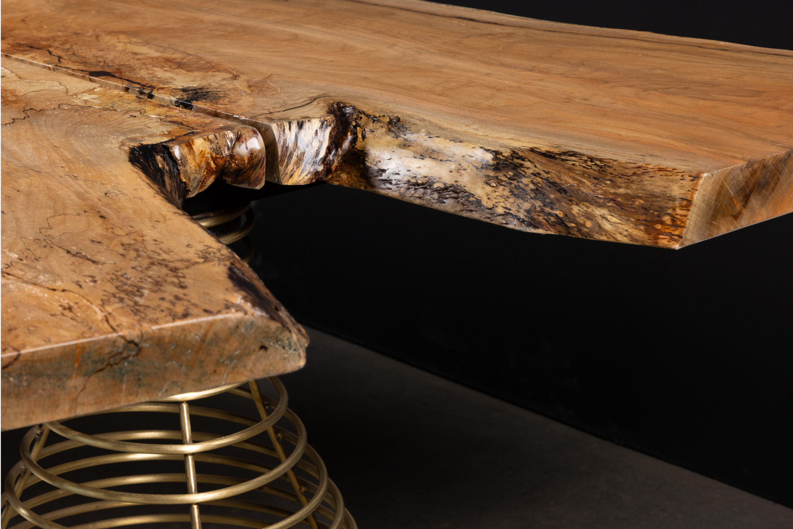 SENTIENT Rivulet Table in Live Edge Splatted Maple Closeup A closeup detail of the live edge splatted maple surface of the SENTIENT Rivulet Table, showcasing the unique texture and natural wood grain.