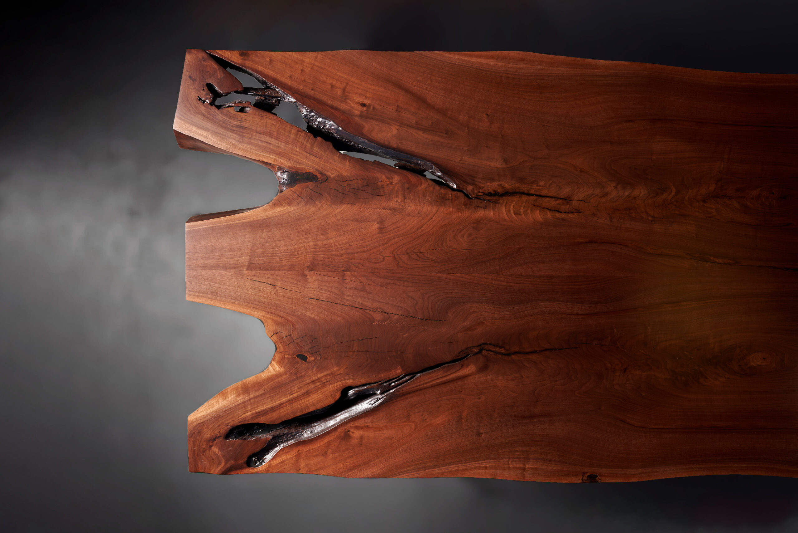 SENTIENT Evolution Artistic Live Edge Table - Top View A top-down view of the SENTIENT Evolution table, showing the smooth, artistic contours of its live edge and the detailed grain of the wood.