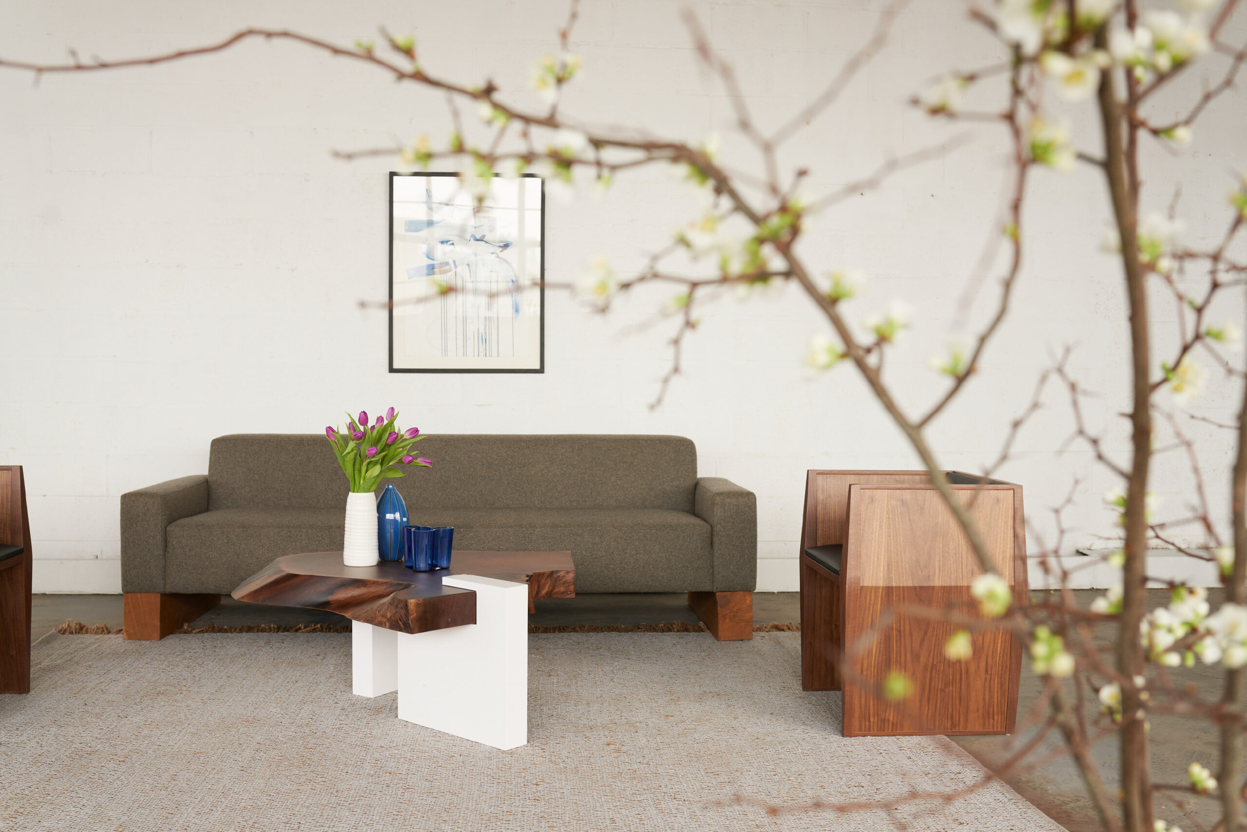 SENTIENT's Sylvan Live-Edge Coffee Table and Beam Sofa in a Modern Living Space Elegant living room setup featuring SENTIENT's Sylvan live-edge coffee table and Beam sofa, styled with contemporary decor elements.