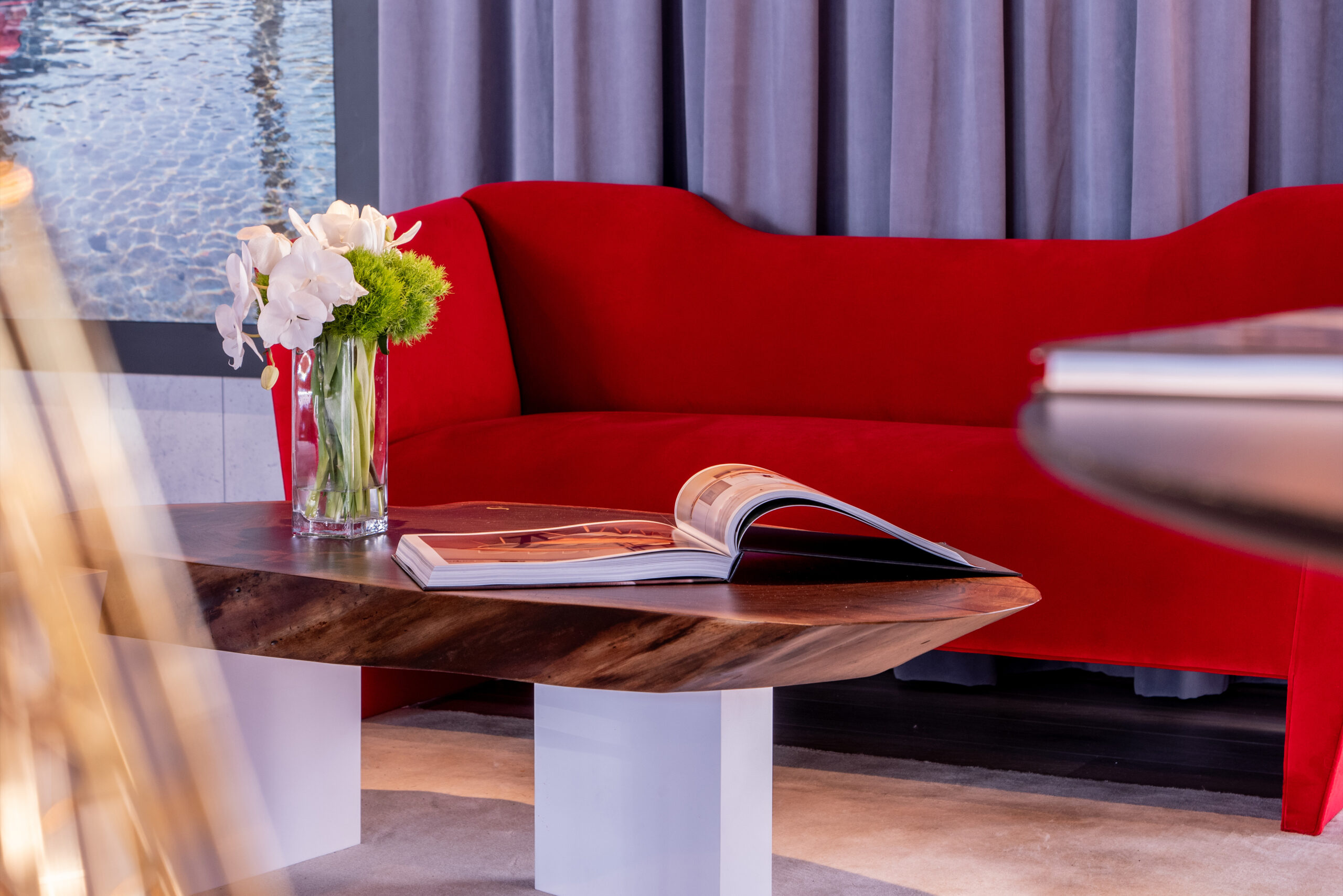 SENTIENT Live Edge Sylvan Coffee Table and NERSI Sofa Stylish setup featuring the SENTIENT Live Edge Sylvan coffee table paired with a vibrant red NERSI sofa, creating a bold and modern interior aesthetic.