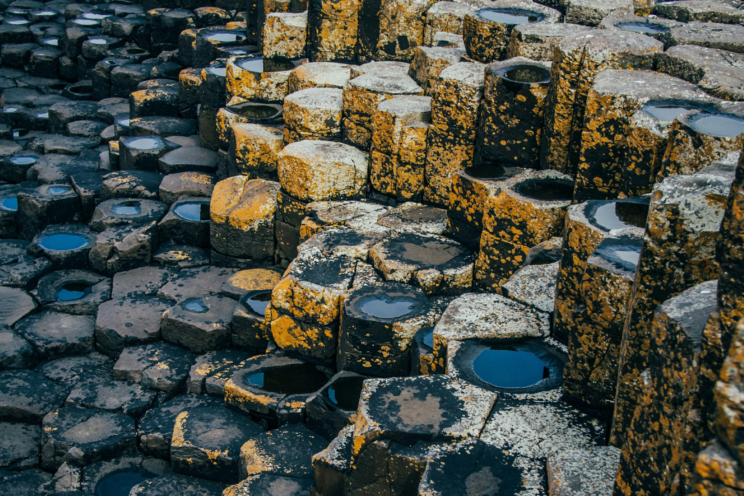 Giant’s Causeway Rocks - Inspiration for SENTIENT Causeway Table Close-up of the Giant’s Causeway rocks in Ireland, capturing the unique hexagonal shapes that inspired the design of the SENTIENT Causeway Table.