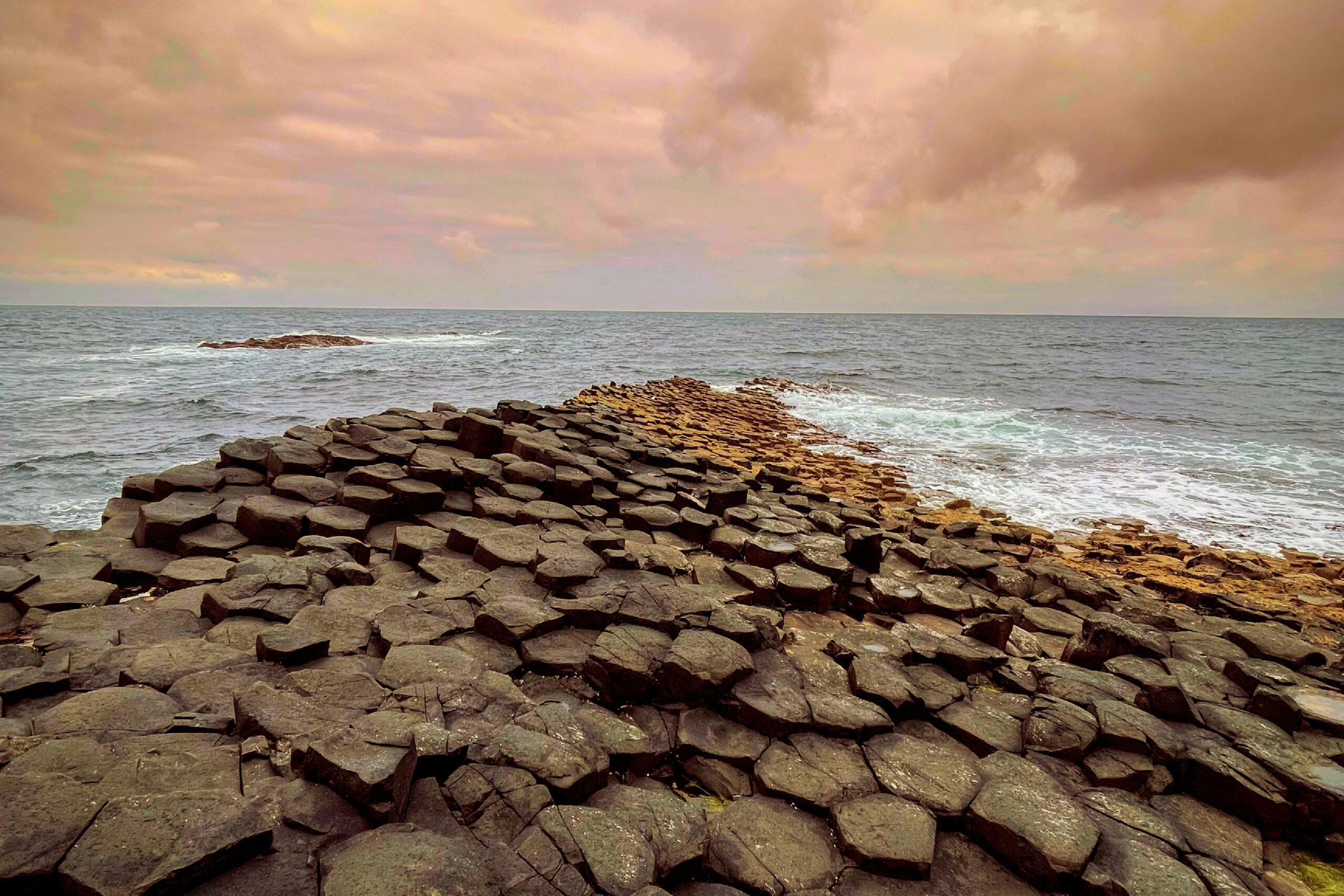 Giant’s Causeway Rocks - Inspiration for SENTIENT Causeway Table : Close-up of the Giant’s Causeway rocks in Ireland, capturing the unique hexagonal shapes that inspired the design of the SENTIENT Causeway Table.