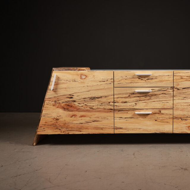 The SENTIENT Luxor Credenza crafted from spalted maple, featuring bold grain patterns and a sleek modern design. Equipped with clean-lined handles and ample storage, it blends natural beauty with functionality.