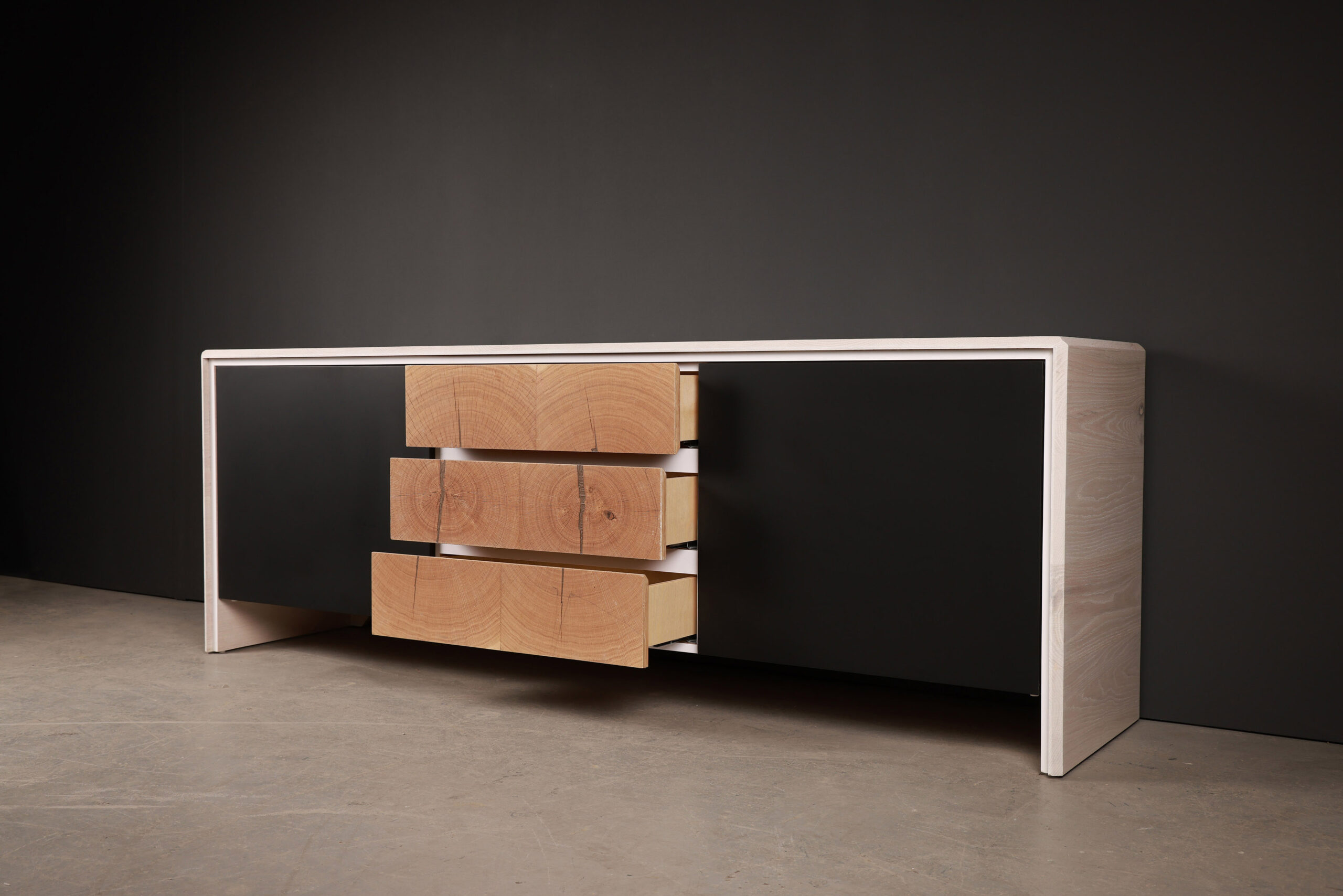 METAMORPH CHAIR SENTIENT Escondido Credenza in Parota Wood (Close Up). High-quality image showcasing the design and details by SENTIENT Furniture.